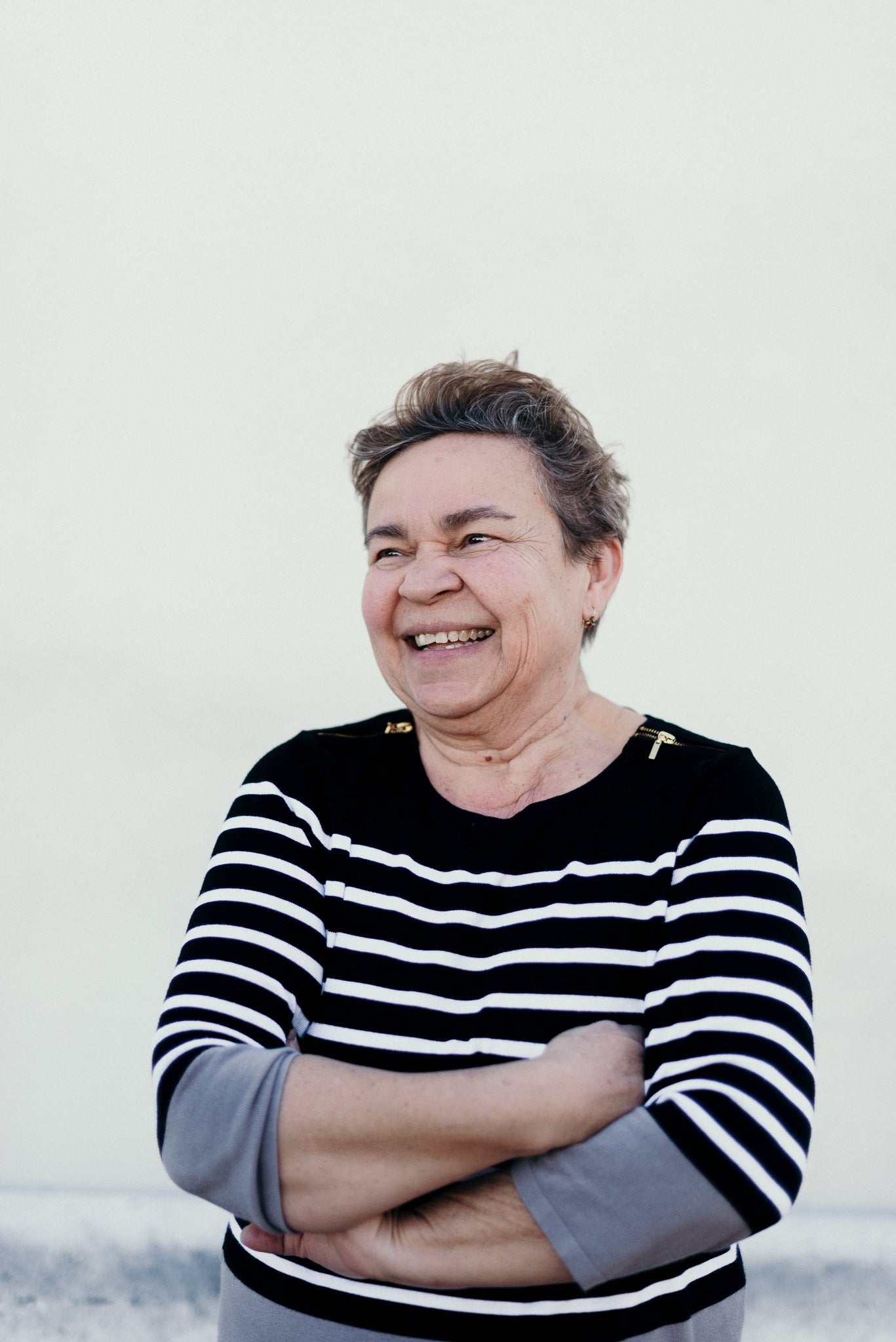 files/a-woman-smiles-with-arms-crossed.jpg